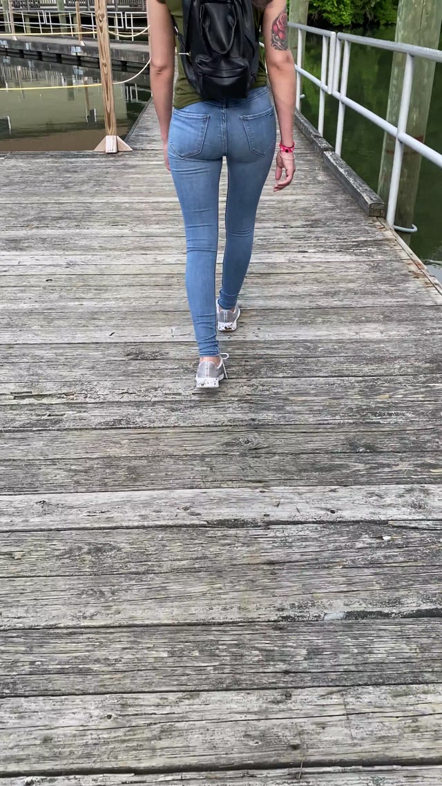 Girl wetting jeans outside