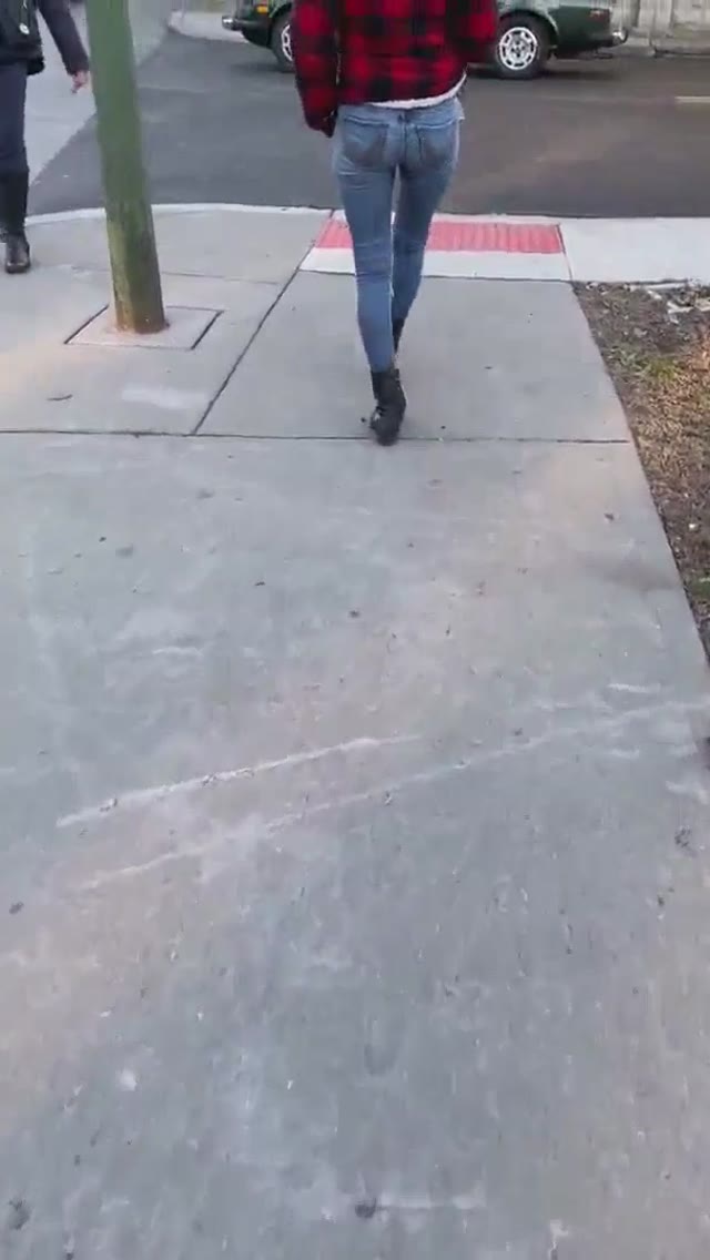 Girl Wetting Jeans On The Street With People Around