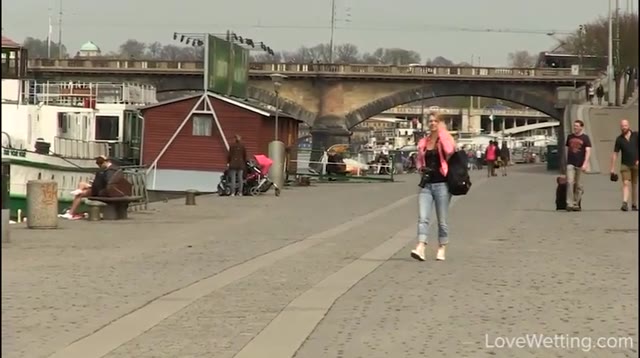 Photographer girl wets her jeans on bridge