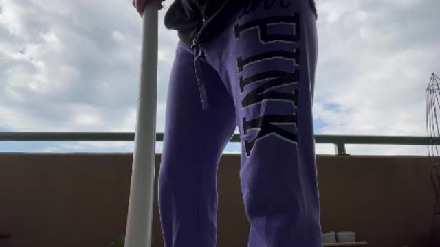 Jogging pissing on balcony